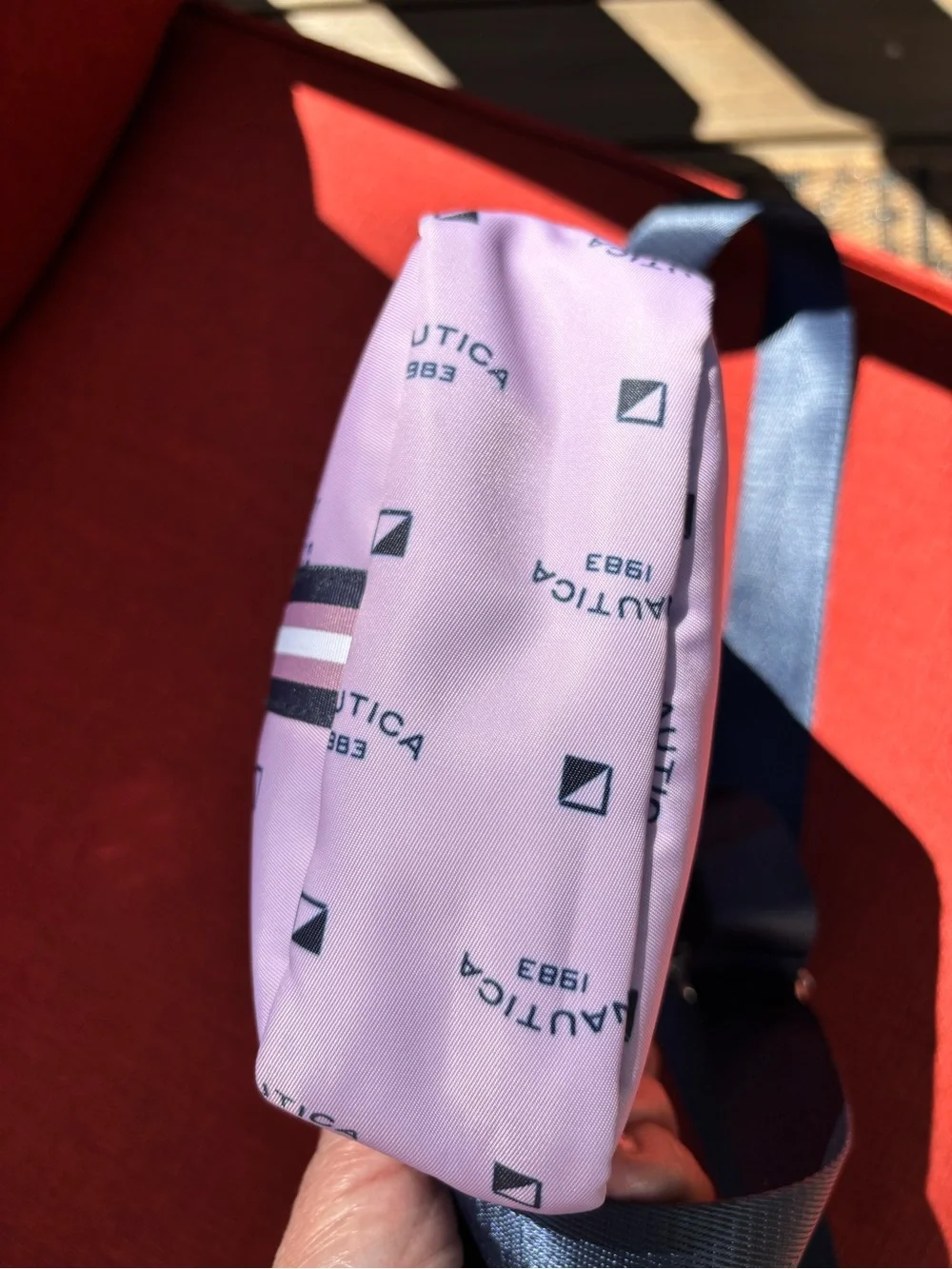 Nautica Pink Logo Print Crossbody Bag with Navy Strap and trim.
